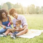 healthy family laughing during grass picnic