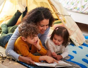 mother reading a book to her children