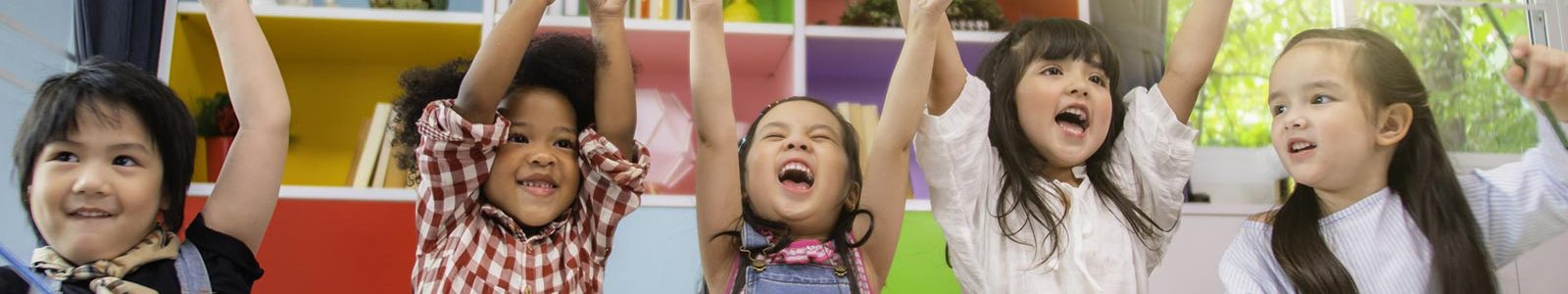 Young children cheering in a classroom